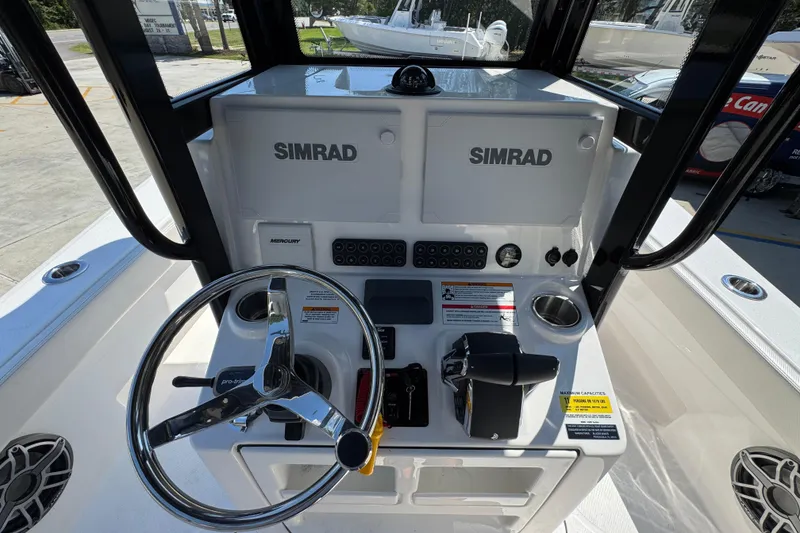 Slide: The Image of 2026 Blazer 2800 Makaira boat console with Simrad electronics and steering wheel. - 33