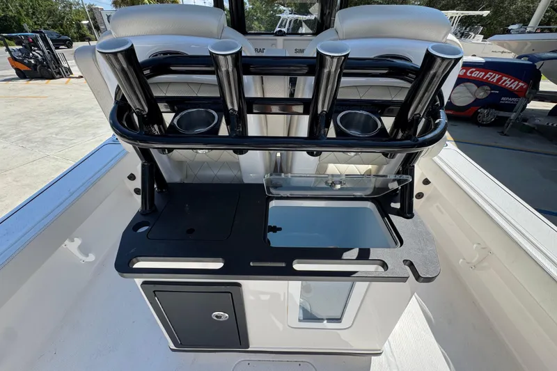 Slide: The Image of 2026 Blazer 2800 Makaira boat console with rod holders and storage compartments. - 37