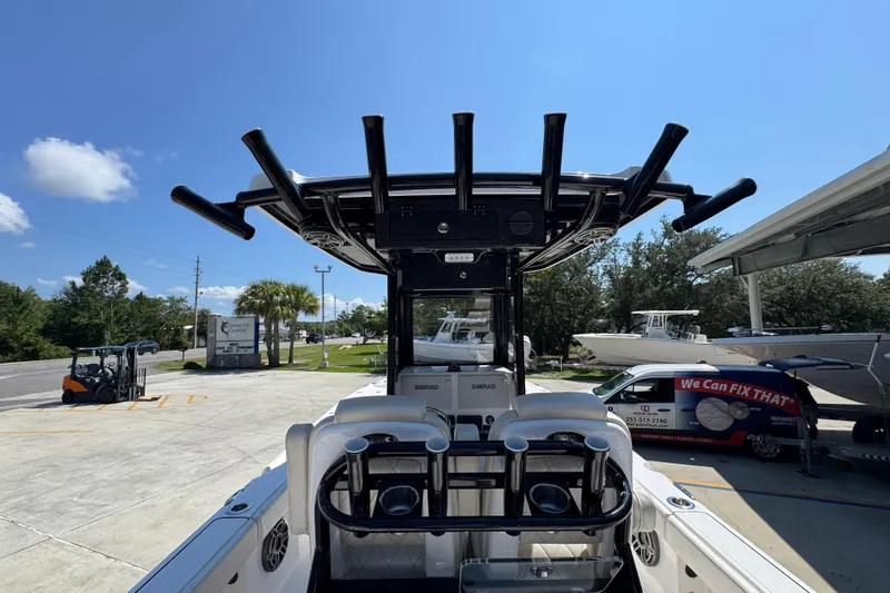 Slide: The Image of 2026 Blazer 2800 Makaira boat with T-top and rod holders in a sunny marina. - 38