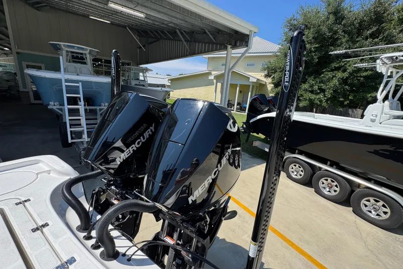 Slide: The Image of 2026 Blazer 2800 Makaira with dual Mercury outboard engines in a boatyard setting. - 41