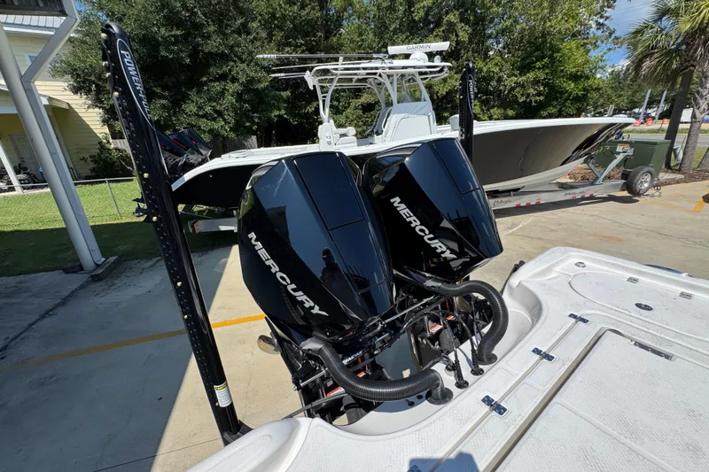 Slide: The Image of 2026 Blazer 2800 Makaira boat with dual Mercury engines, parked outdoors. - 42