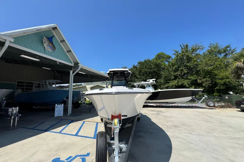 Slide: The Image of 2026 Blazer 2800 Makaira boat on trailer at marina under clear blue sky. - 6
