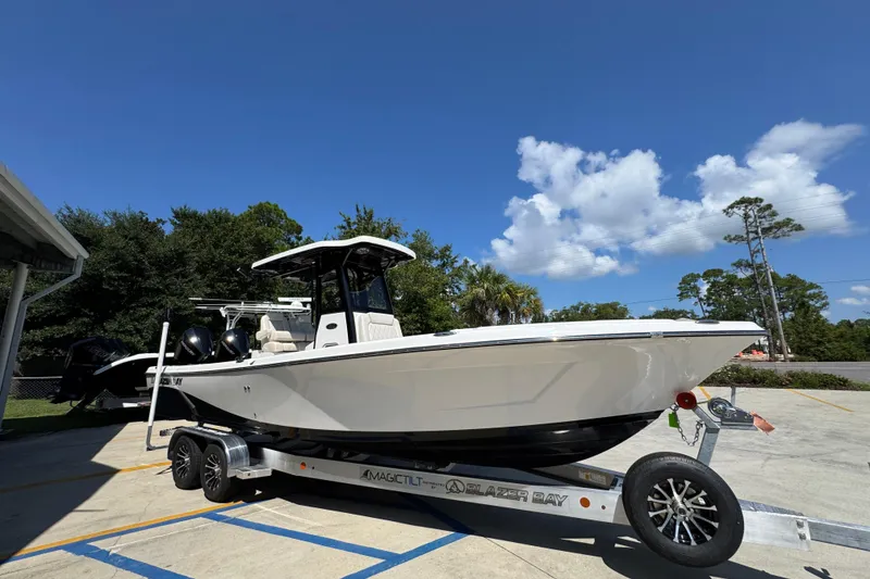 Slide: The Image of 2026 Blazer 2800 Makaira boat on trailer under clear blue sky. - 8