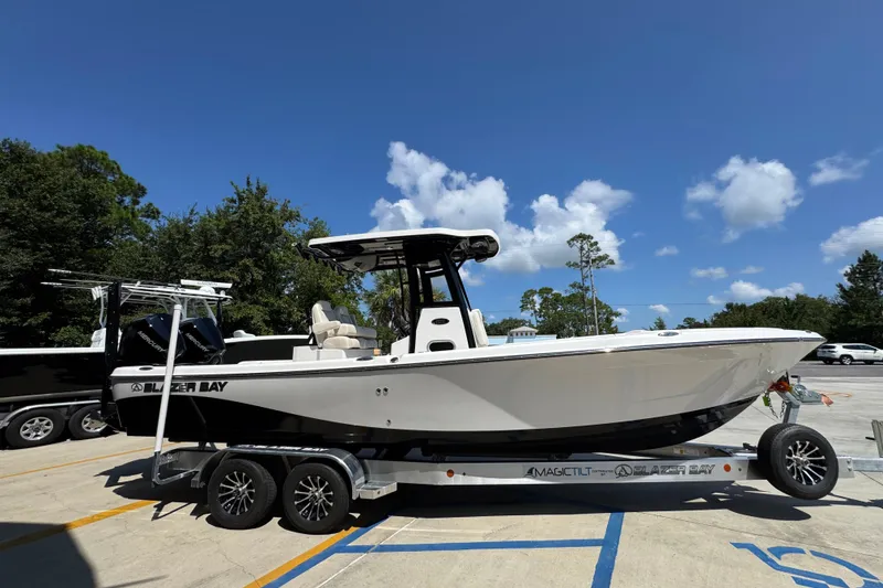 Slide: The Image of 2026 Blazer 2800 Makaira boat on trailer, parked outdoors under clear blue sky. - 9