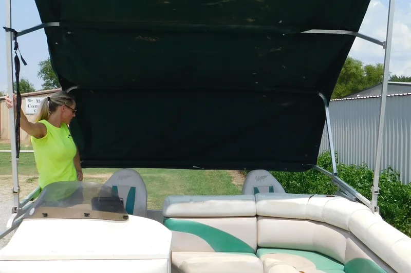 Slide: The Image of 2001 Voyager Pontoons VF20 with canopy, woman in bright shirt adjusting frame. - 4