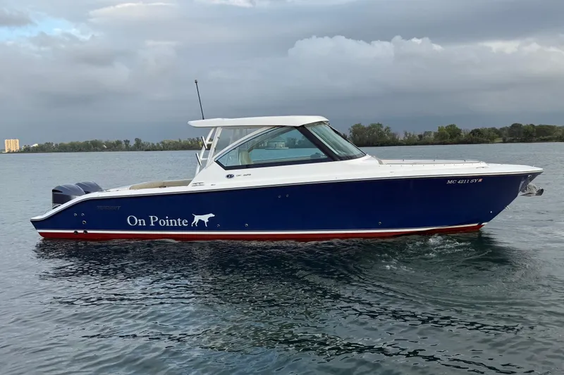 The Image of 2016 Pursuit DC 325 Dual Console boat named "On Pointe" on calm water. - 0