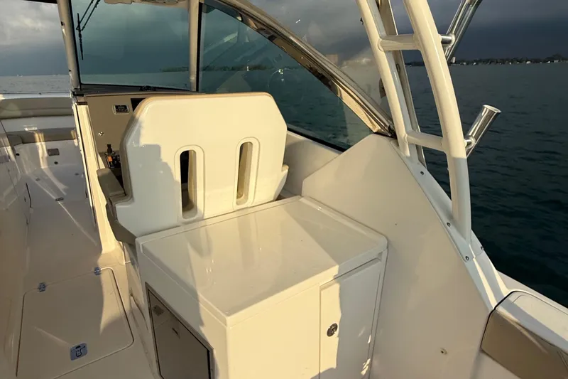 Slide: The Image of 2016 Pursuit DC 325 Dual Console boat interior with seating and ocean view. - 26