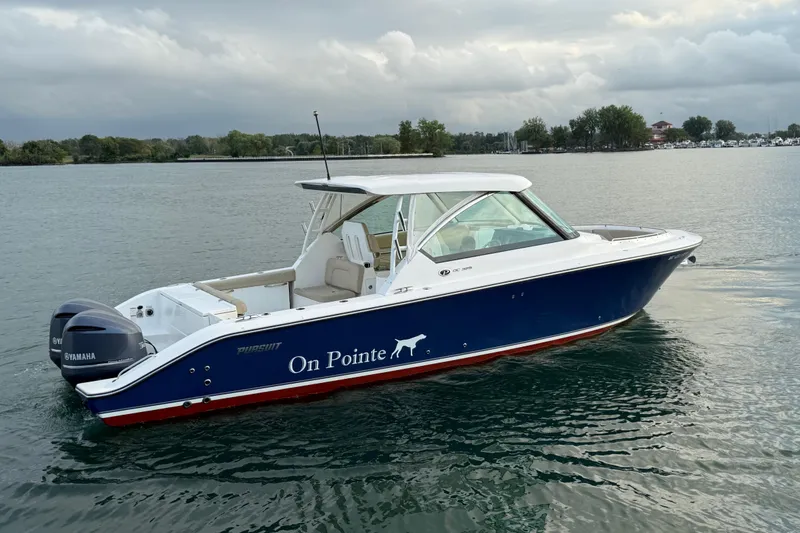 Slide: The Image of 2016 Pursuit DC 325 Dual Console boat on water, featuring Yamaha engines. - 3