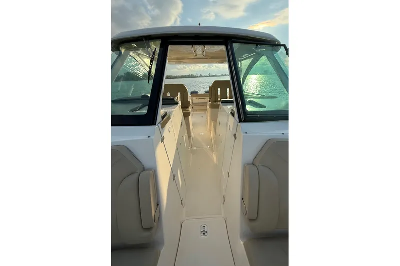 Slide: The Image of 2016 Pursuit DC 325 Dual Console boat interior with scenic water view. - 34
