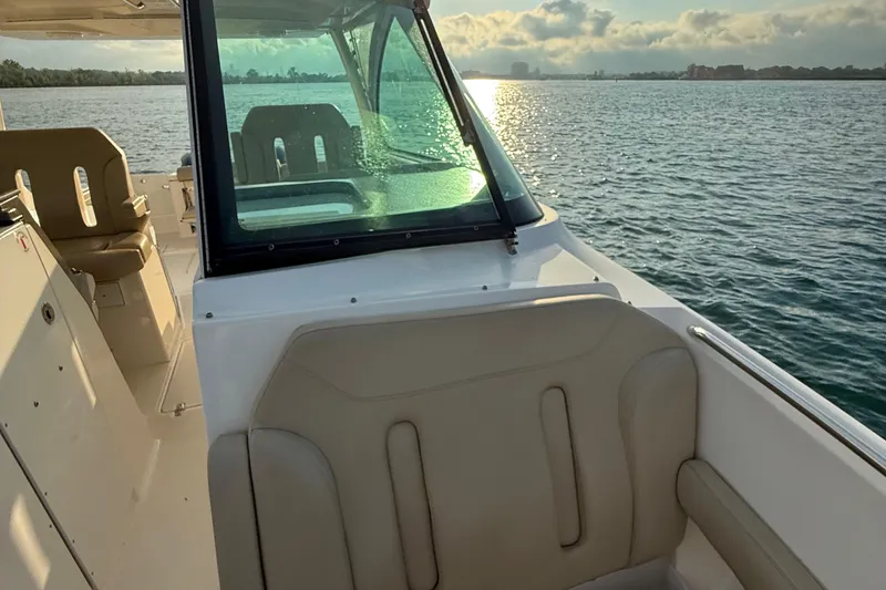 Slide: The Image of 2016 Pursuit DC 325 Dual Console boat on water at sunset. - 35