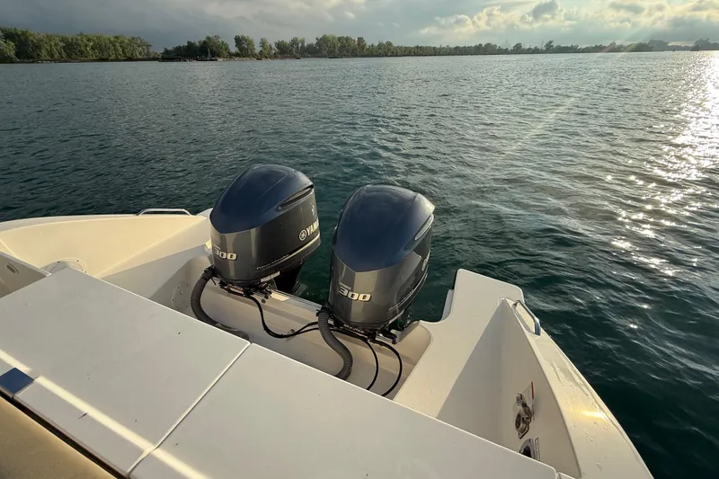 Slide: The Image of 2016 Pursuit DC 325 Dual Console with twin Yamaha engines on calm water. - 42