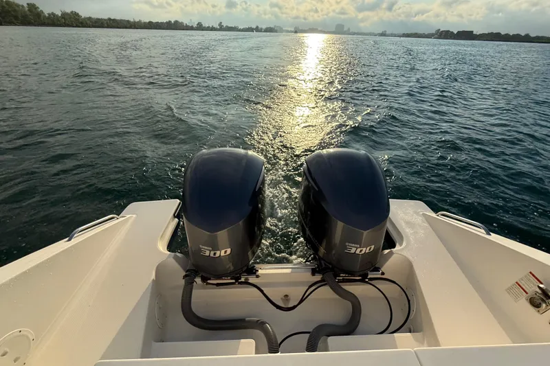 Slide: The Image of 2016 Pursuit DC 325 Dual Console boat with twin Yamaha 300 engines on open water. - 43