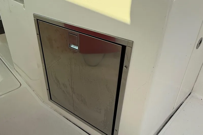 Slide: The Image of Stainless steel compartment door on 2016 Pursuit DC 325 Dual Console boat. - 49
