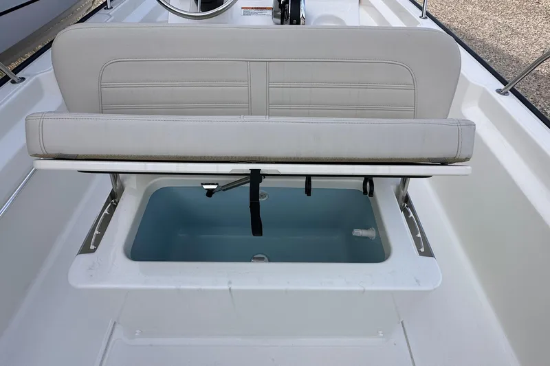 Slide: The Image of 2026 Boston Whaler 170 Montauk boat seat with storage compartment open. - 10