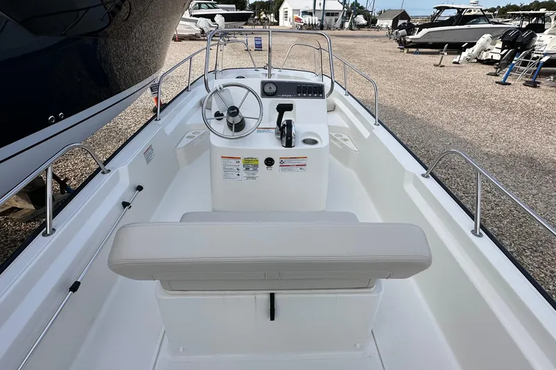 Slide: The Image of 2026 Boston Whaler 170 Montauk boat interior with steering wheel and seating. - 11