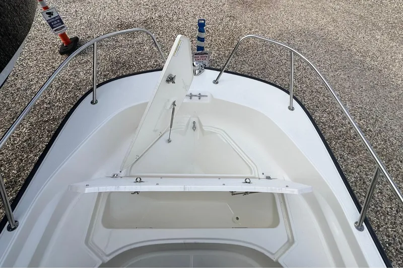 Slide: The Image of 2026 Boston Whaler 170 Montauk boat bow with open storage compartment. - 18