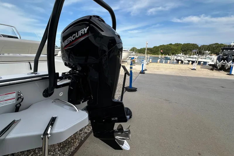 Slide: The Image of 2026 Boston Whaler 170 Montauk with Mercury outboard motor at marina. - 4