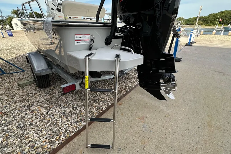 Slide: The Image of 2026 Boston Whaler 170 Montauk boat with ladder and outboard motor on trailer. - 6