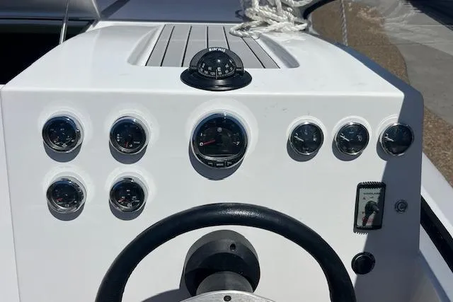 Slide: The Image of Steering console of 2024 Bracewell 25 boat with gauges and compass. - 15