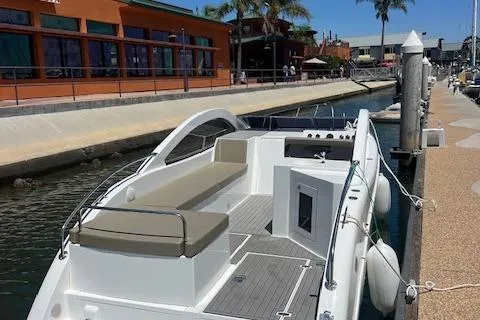 Slide: The Image of 2024 Bracewell 25 boat docked at a marina with modern design and spacious seating. - 22