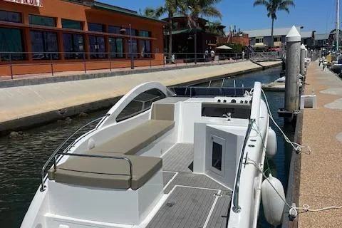 Slide: The Image of 2024 Bracewell 25 boat docked at a marina with modern design and spacious seating. - 23