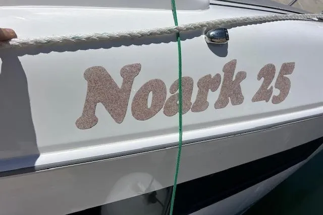 Slide: The Image of Boat with "Noark 25" text, 2024 Bracewell model, white hull, docked with rope. - 30