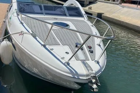 Slide: The Image of 2024 Bracewell 25 boat docked in marina, sleek design, white exterior. - 5