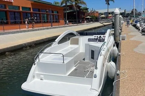 Slide: The Image of 2024 Bracewell 25 boat docked at marina with waterfront buildings in background. - 6