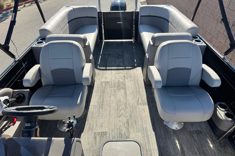 Slide: The Image of Interior of 2023 Apex Qwest 822 pontoon boat with gray seating and steering wheel. - 12