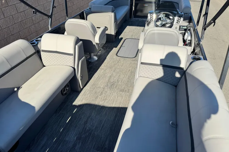 Slide: The Image of Interior of 2023 Apex Qwest 822 pontoon boat with gray seating and steering console. - 18