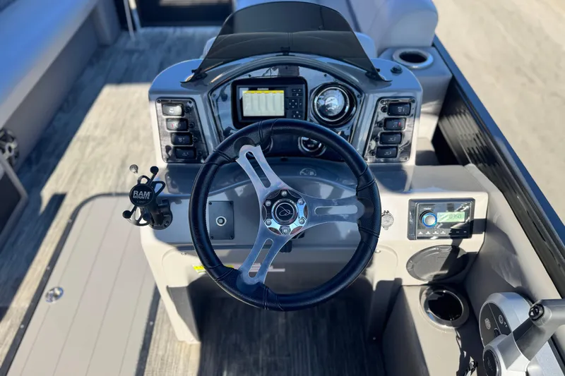 Slide: The Image of 2023 Apex Qwest 822 boat dashboard with steering wheel and control panel. - 22