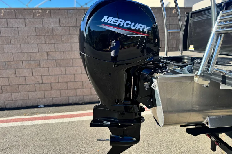 Slide: The Image of Outboard motor on 2023 Apex Qwest 822 boat, featuring a sleek Mercury engine design. - 7