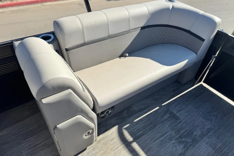 Slide: The Image of 2023 Apex Qwest 822 boat interior with gray cushioned seating and cup holders. - 14