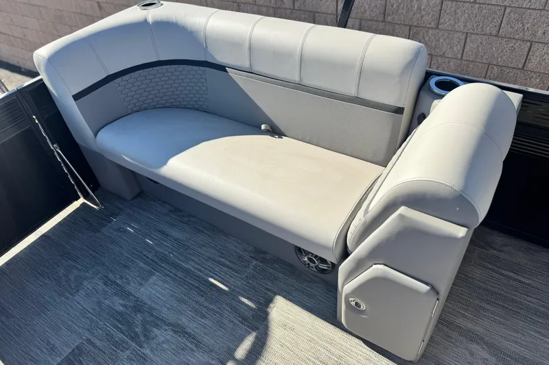 Slide: The Image of Luxurious seating on 2023 Apex Qwest 822 boat, featuring sleek gray upholstery and cup holders. - 15