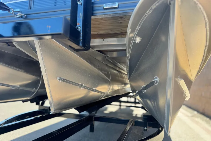 Slide: The Image of 2023 Apex Qwest 822 pontoon boat underside, showcasing aluminum pontoons and trailer. - 3