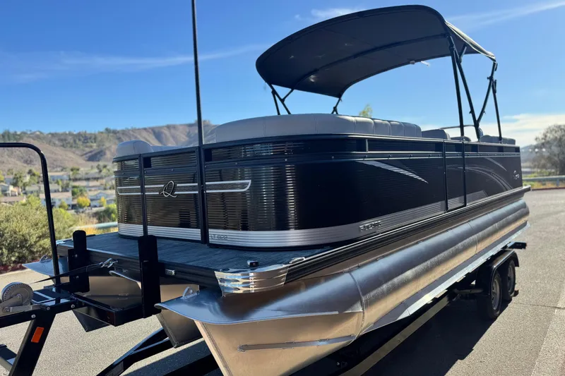 Slide: The Image of 2023 Apex Qwest 822 pontoon boat on trailer, scenic background, sunny day. - 4
