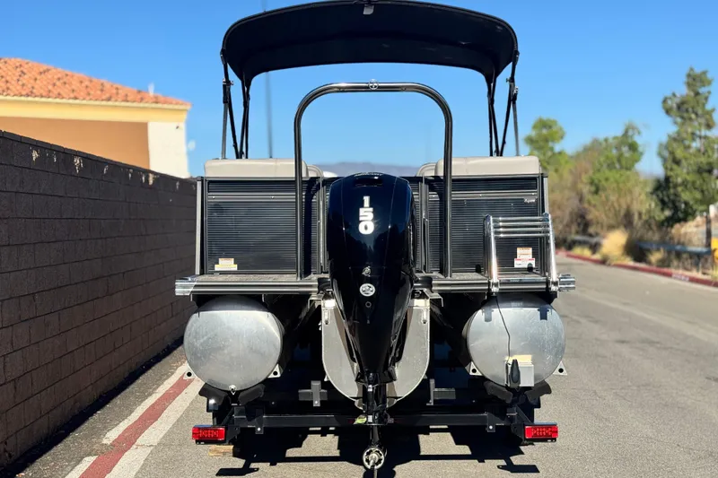 Slide: The Image of 2023 Apex Qwest 822 pontoon boat with 150 HP engine on a sunny day. - 5