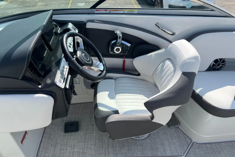 Slide: The Image of 2026 Crownline 270 SS boat interior with sleek steering wheel and comfortable seating. - 12