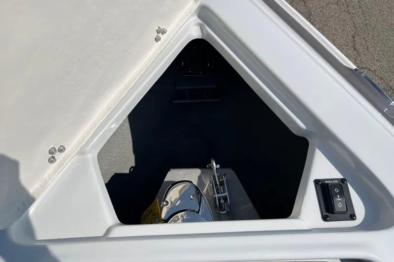 Slide: The Image of 2026 Crownline 270 SS boat anchor compartment with winch controls. - 4