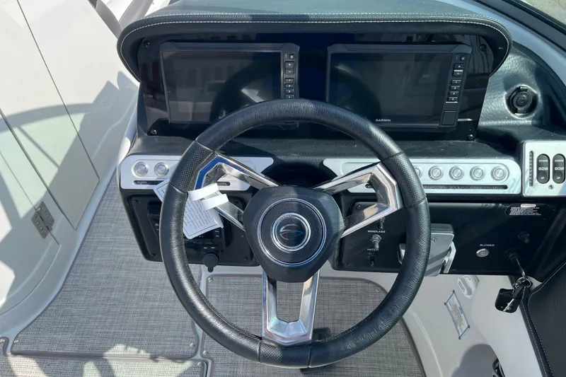 Slide: The Image of 2026 Crownline 270 SS boat dashboard with steering wheel and dual Garmin displays. - 8