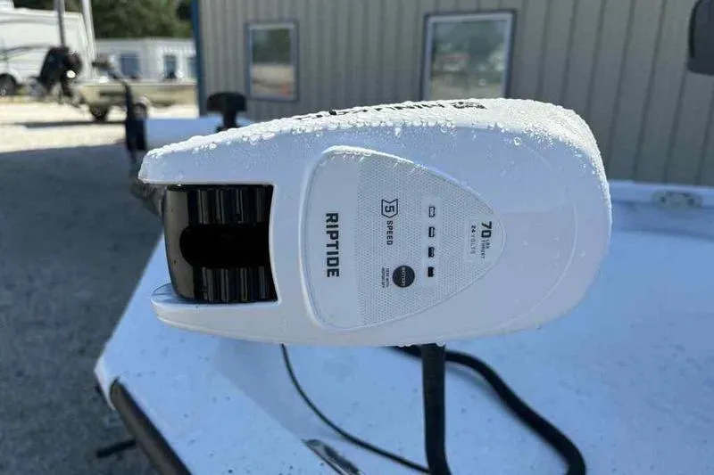 Slide: The Image of Riptide motor on Xpress H20B boat, 2026 model, with water droplets. - 12