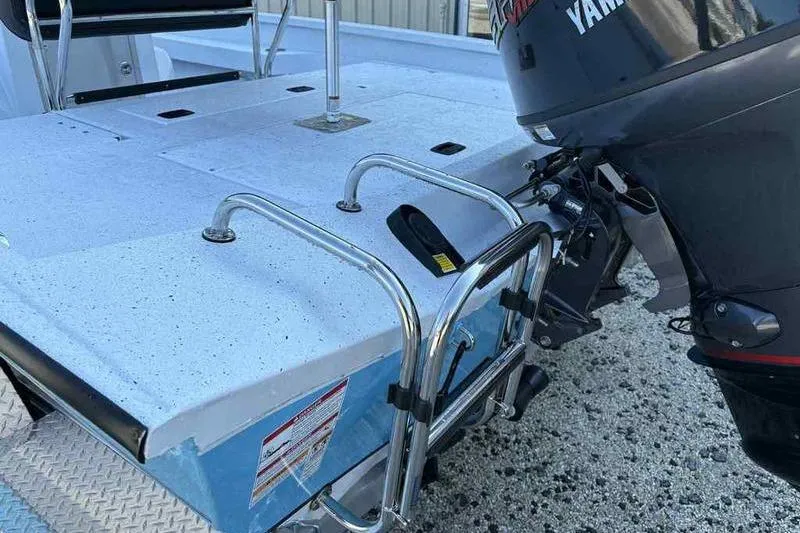 Slide: The Image of 2026 Xpress H20B boat with Yamaha outboard motor and swim ladder. - 13