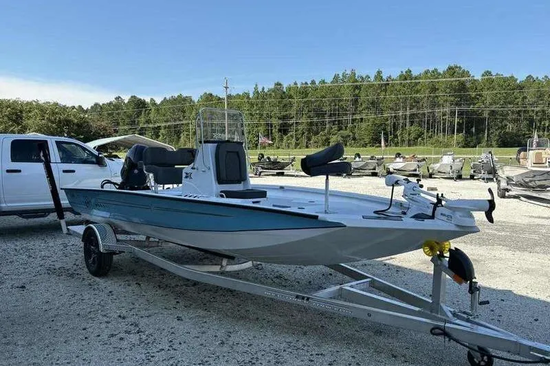 Slide: The Image of 2026 Xpress H20B boat on trailer, parked outdoors near a white truck. - 4