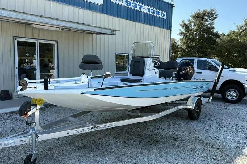 Slide: The Image of 2026 Xpress H20B boat on trailer outside dealership, featuring sleek design and modern equipment. - 5