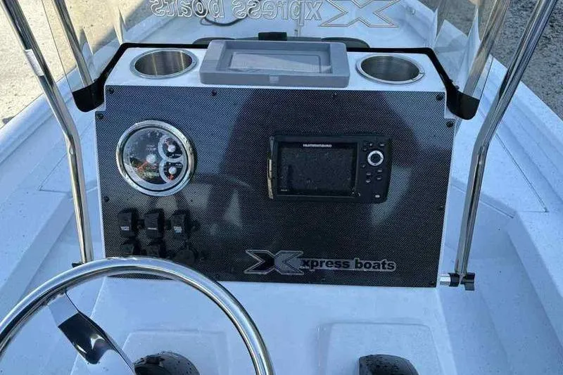 Slide: The Image of 2026 Xpress H20B boat dashboard with steering wheel, gauges, and electronic display. - 7