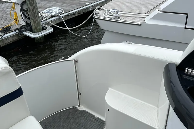 Slide: The Image of 2016 Formula 40 Cruiser boat docked, featuring white seating and deck details. - 16