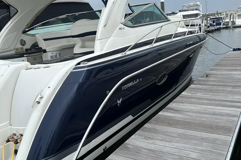 Slide: The Image of 2016 Formula 40 Cruiser yacht docked at marina, showcasing sleek design and luxury features. - 2