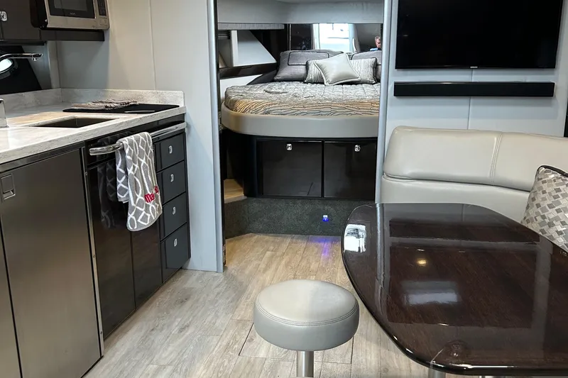 Slide: The Image of 2016 Formula 40 Cruiser interior with modern kitchen, cozy bed, and sleek dining area. - 20