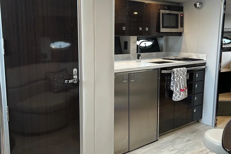 Slide: The Image of 2016 Formula 40 Cruiser interior kitchen with modern appliances and sleek cabinetry. - 21