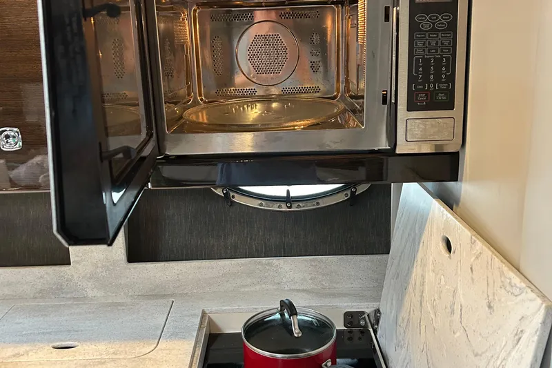 Slide: The Image of Microwave and stove in 2016 Formula 40 Cruiser yacht kitchen. - 45